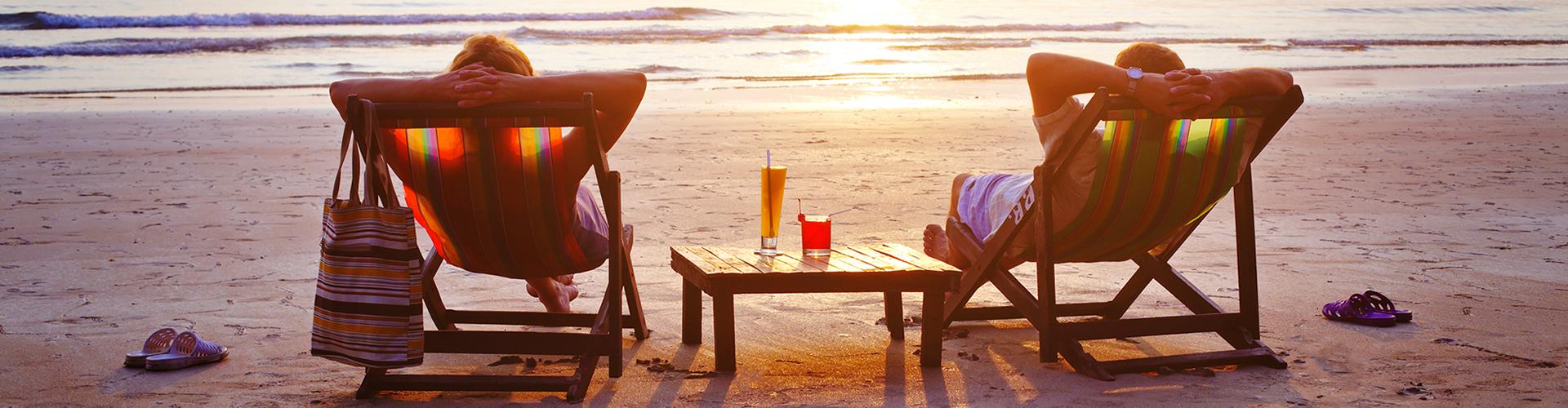 Investments Header: Retired Couple relaxing on beach