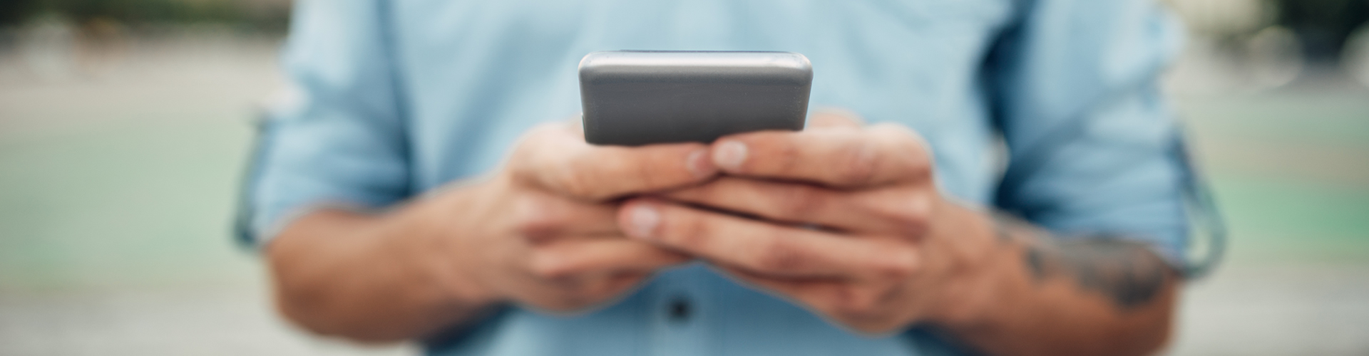 Online Banking Header: Person checking mobile device